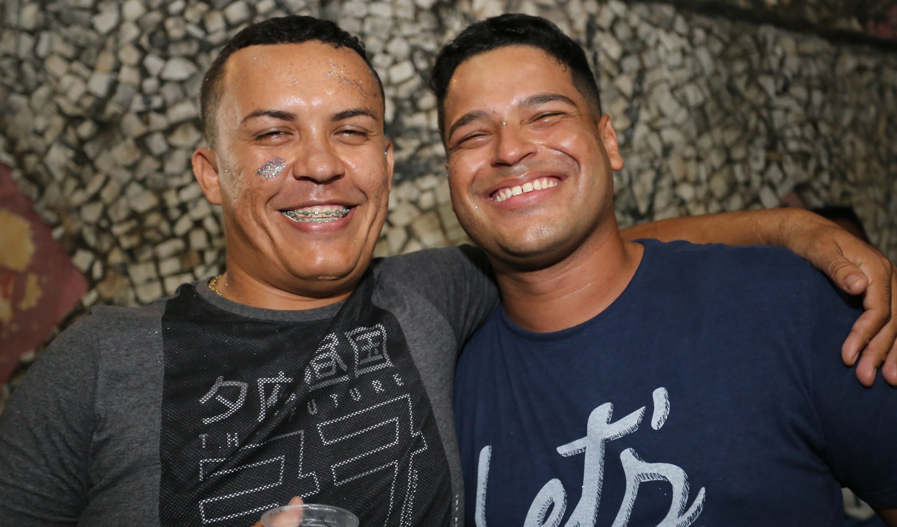 dois rapazes lado a lado sorrindo para a foto